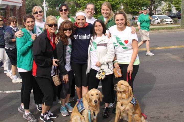 Jenn Marr (Got Comfort shirt) stands with people in Saturday&#x27;s race and comfort dogs Addie and Maggie.