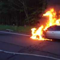 <p>A 1992 Toyota Camry is fully engulfed in flames Monday night on the northbound Merritt Parkway. </p>