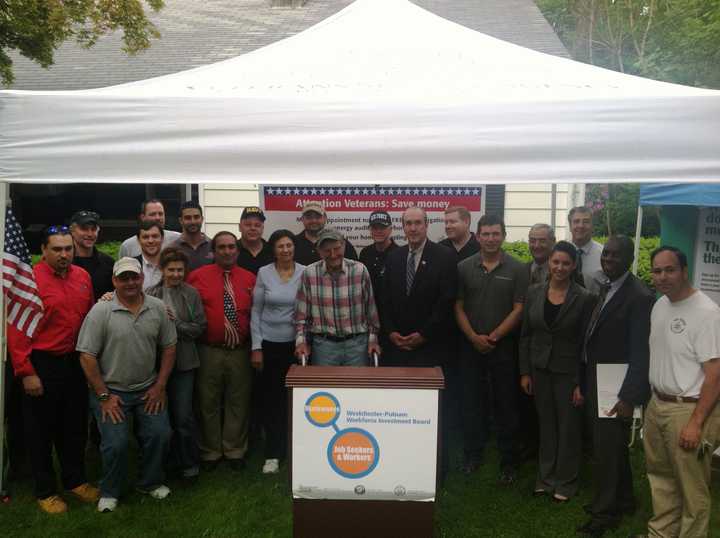 Ossining veteran Victor Paolantonio and his wife, center, are surrounded by local contractors who donated more than $20,000 in energy upgrades to the couple&#x27;s home. 