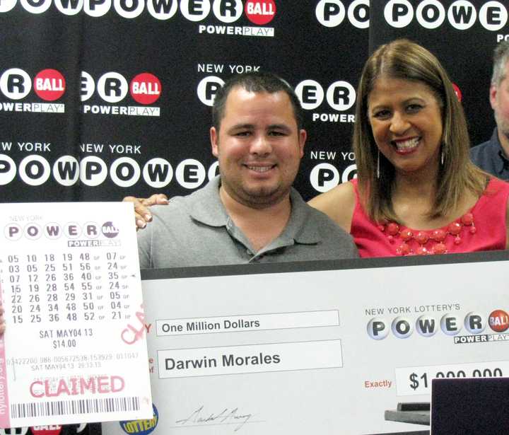 Somers resident Darwin Morales received an oversized check Tuesday in Fishkill from New York Lottery&#x27;s Yolanda Vega for $1 million.