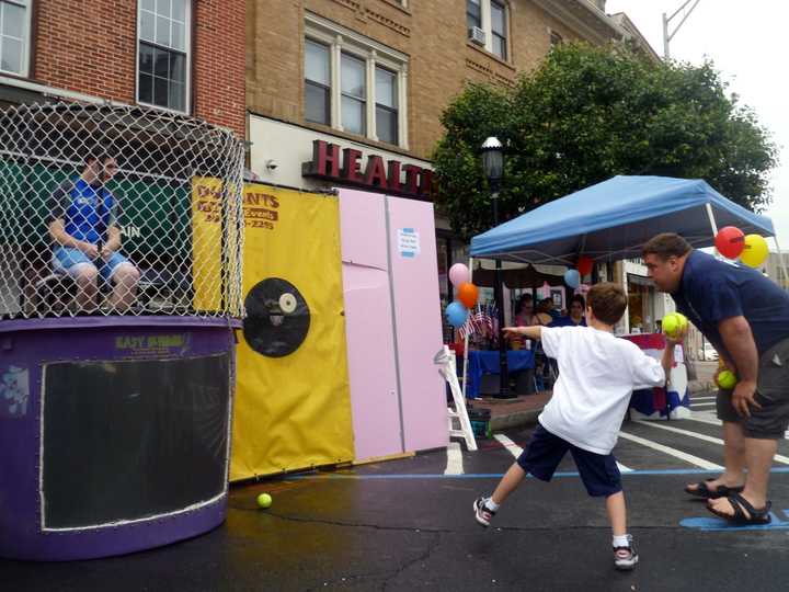 Six-year-old Charlie Carpenter takes aim at the dunk tank at last year&#x27;s Ossining Village Fair.