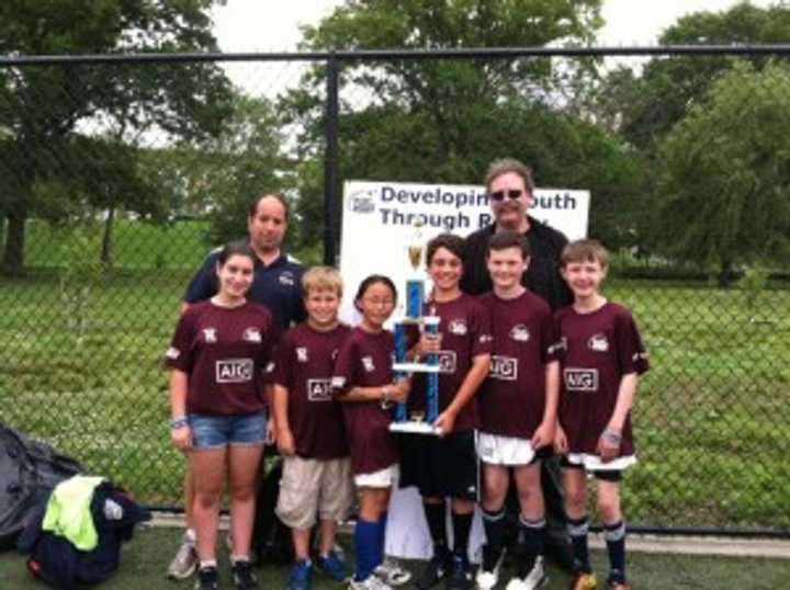 The Pelham elementary flag team and coaches held their trophy for winning the NYC Cup Division.