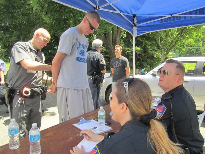 Cortlandt Manor volunteer Dylan Stewart is &quot;arrested and processed&quot; during the annual Westchester County Mutual Aid exercise at Valhalla&#x27;s Westchester Community College. 