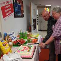 <p>David Juhren joins Karen Carr and her wife Yvette Christofilis (Irvington) in cutting a rainbow cake to celebrate the Supreme Court decisions on DOMA and Prop 8. </p>