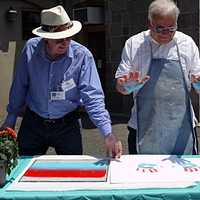 <p>Mayor Richard Moccia participates in the first annual Norwalk Art Festival by creating a hand print in front of the Center for Contemporary Print Making at Mathews Park.</p>