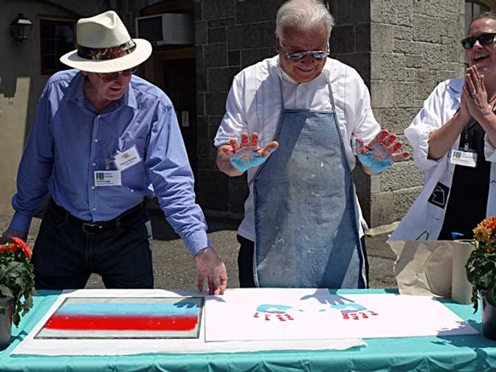 Mayor Richard Moccia participates in the first annual Norwalk Art Festival by creating a hand print in front of the Center for Contemporary Print Making at Mathews Park.