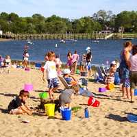 <p>Families relax on a bright, sunny day at Weed Beach in Darien. But the beach exceeds the state&#x27;s daily maximum bacterial standard about 19 percent of the time, according to a recent report. 
</p>