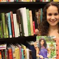 <p>Briana Andreoli, of Mamaroneck, gets ready to have her copy of, &quot;Fabulicious: On the Grill,&quot; signed by author and real housewife Teresa Giudice at Barnes and Noble in White Plains on July 11.</p>