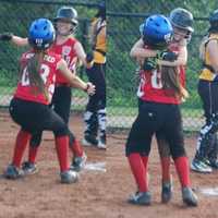 <p>Fairfield&#x27;s Bridget Keary gets a hug from teammate Kylee Holderied after scoring the winning run.</p>