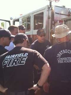 Fairfield Firefighters Changing Batteries Of Smoke Detector For Seniors