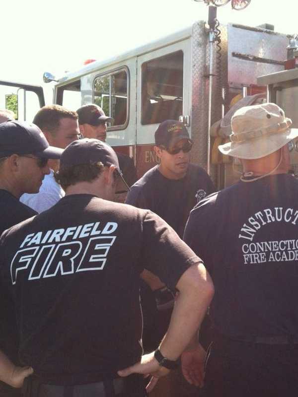 Fairfield Firefighters Changing Batteries Of Smoke Detector For Seniors