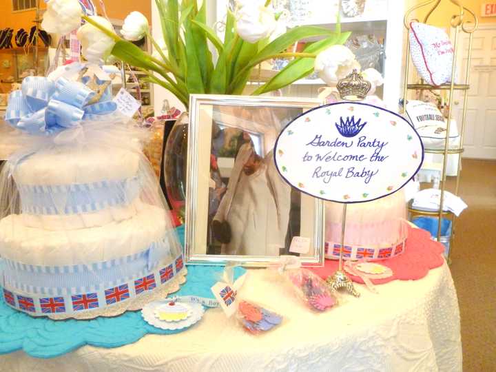 Deb Hecht, owner of Goldenberry in New Canaan, decorated a table with a birthday cake, flowers, and a photo of Kate Middleton in honor of the Royal Baby&#x27;s birth. 