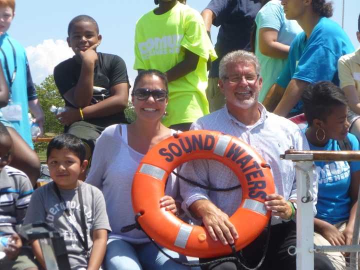Jeanne Melino, of the Steven and Alexandra Cohen Foundation, and Michael Duggan, executive director of Domus, are joined on the SoundWaters Schooner by about 25 campers from Domus on Monday afternoon. 