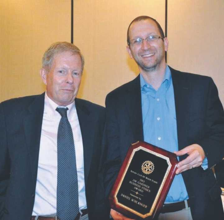 Lawyer Daniel Schlanger, right, receives the award from Mike Baker.