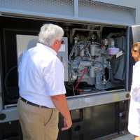 <p>Tuckahoe Mayor Steve Ecklond showing Assemblywoman Amy Paulin the inside of the new generator.</p>