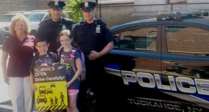 Tuckahoe Police Officers James Kennedy and Philip Magaletti kick off the school safety campaign with Jake and Kayla Yankowski and AAA New York&#x27;s Donna Galasso.