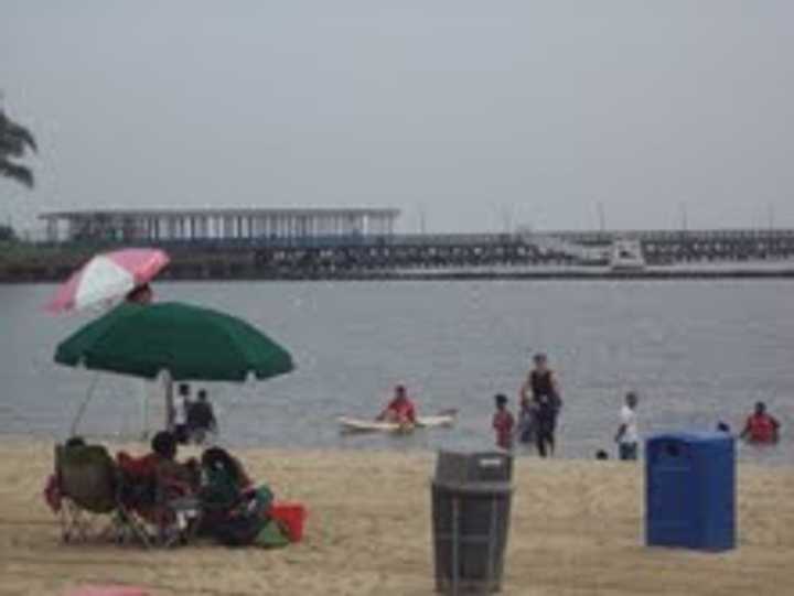 People soak up the last day of summer at Playland Beach.