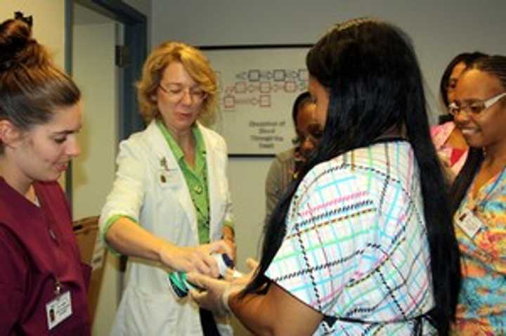 Nursing students learn about the importance of handling latex gloves.