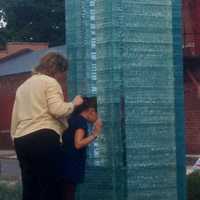 <p>Friends of a Sept. 11 victim pay an up-close visit to Danbury&#x27;s memorial before the ceremony Wednesday evening. </p>