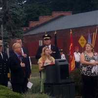 <p>Amanda Higley, whose father died in the World Trade Center on Sept. 11, 2001, sings &quot;God Bless America&quot; at the Danbury memorial service. </p>