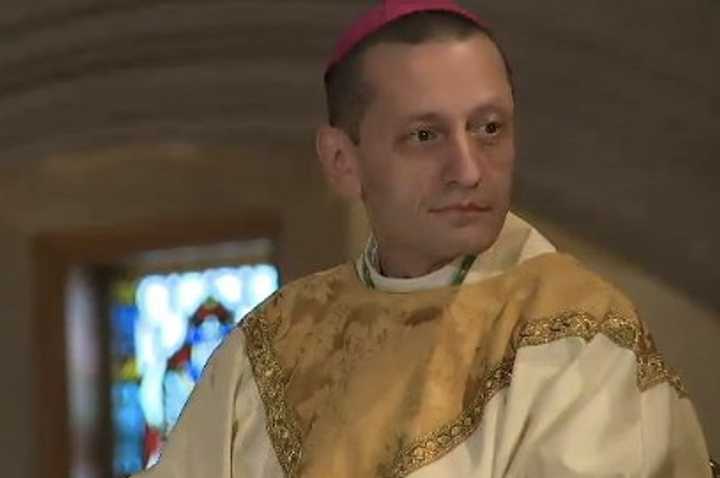 Bishop Frank J. Caggiano takes his place at the front of St. Theresa Roman Catholic Church in Trumbull before the Mass begins. 