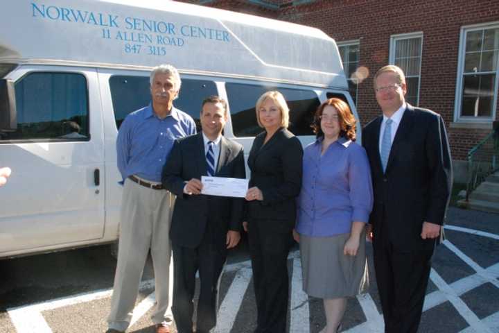 State Sen. Bob Duff (D-Norwalk) joins the Director and board members of the Norwalk Senior Center as an Aetna executive presents a $1,000 check to help the Senior Center recover from a recent act of vandalism.