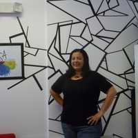 <p>Susan Nagib stands in front of her artwork at Gallery Roc in New Rochelle.</p>