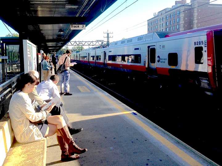 Commuters wait for delayed New Haven line trains at the Mamaroneck Metro-North Station.