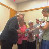 <p>Members of the Daughters of Revolution, League of Women Voters and the National Ladies Auxiliary of the Jewish War Veterans handed the new citizens pamphlets and small American flags after they accepted their certificates.</p>