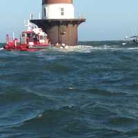 <p>Marine Units from the Norwalk Fire and Police Departments respond to help a boat taking on water near Peck&#x27;s Ledge Lighthouse.</p>