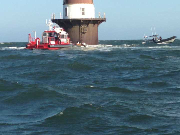 Marine Units from the Norwalk Fire and Police Departments respond to help a boat taking on water near Peck&#x27;s Ledge Lighthouse.