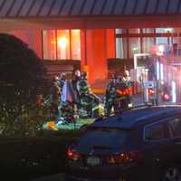 <p>Firefighters relaxing after the flames were knocked down.</p>