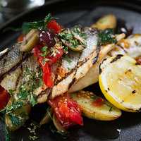 <p>The European seabass, or &quot;Branzino&quot;, is served grilled to perfection with fingerling potatoes, cherry tomatoes, garlic and olives ($20).</p>