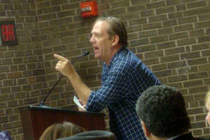 A Harrison parent yells at New York Education Commissioner John King about the Common Core at a public forum held in Port Chester Monday.