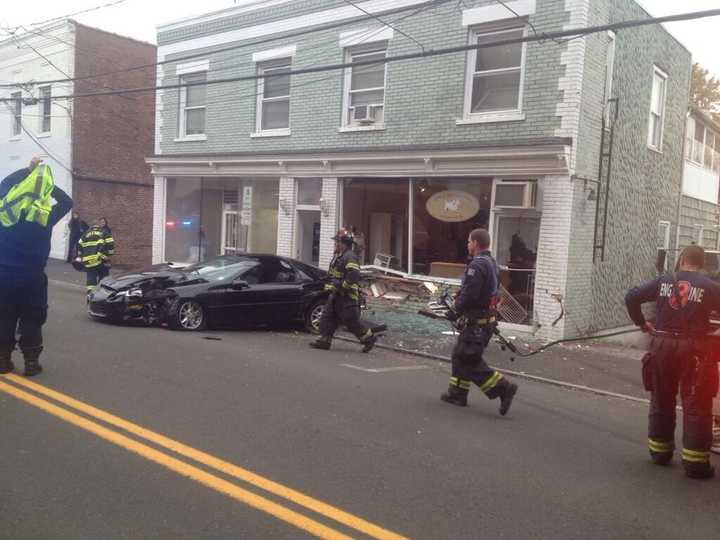 Greenwich firefighters respond after a Camaro slammed into a business on Pemberwick Road. 