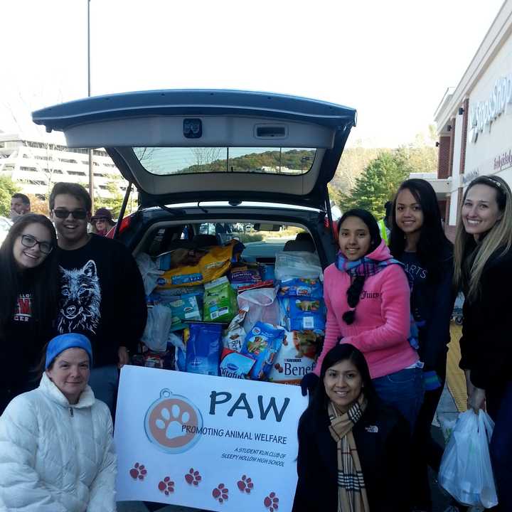 Members of the Sleepy Hollow High School Promoting Animal Welfare club collect donations for Pets Alive Westchester at a recent event.