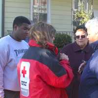 <p>Tamara Garcia-Sanchez, whose home was damaged by the fire, speaks to a Red Cross volunteer. </p>