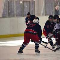 <p>Harvey&#x27;s Corey Eisenband fights for the puck against Stepinac. </p>