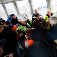 <p>Members of the NTSB team meets with New York local and state officials at the train derailment scene.</p>