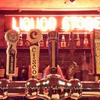 <p>A neon sign from the 1950s decorates the bar area at the Little Barn in Westport.</p>