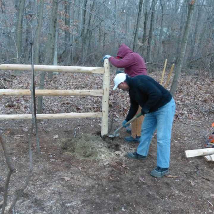 Members of the Yorktown Dog Park Committee construct a fence for the off-leash dog park at Sylvan Glen Park Preserve in Yorktown.