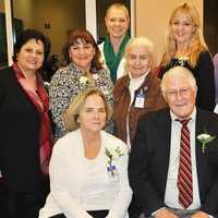 <p>Linda St. Pierre, Joseph Jordan and Dr. Donna Coletti (seated l-r) joined other Home Hospice Program team members at a reception following the Tree of Light ceremony on Monday.
</p>