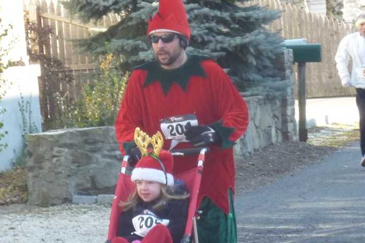 A runner pushes a stroller at the Holiday Run For Toys in Fairfield in last year&#x27;s race.