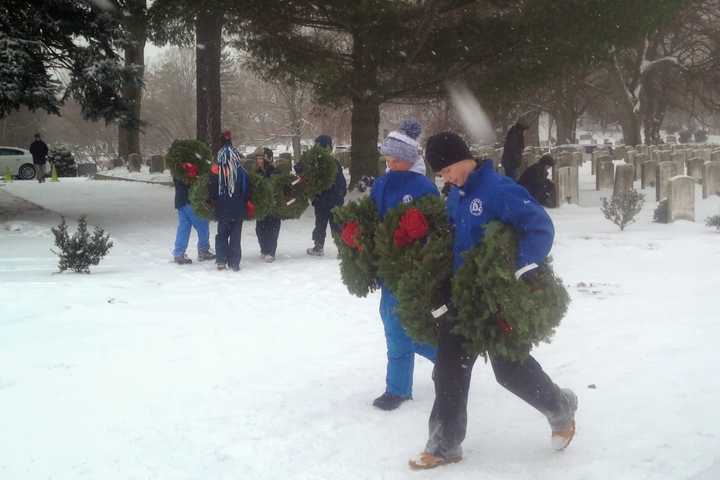 Volunteers participate in national Wreaths Across America Day in Darien on Saturday.