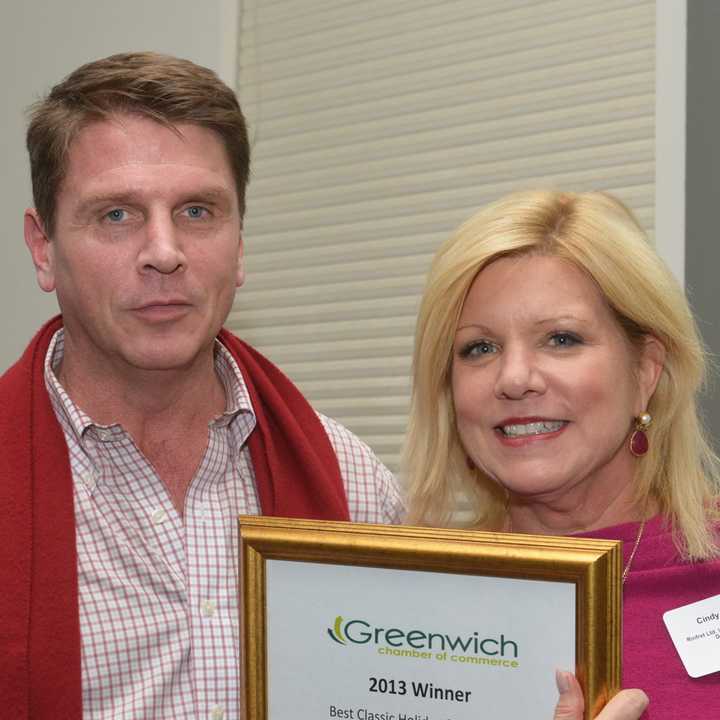 Rinfret Home and Garden&#x27;s shop manager, Jim Farthing, left, and interior designer and shop owner, Cindy Rinfret show off their storefront decoration award.