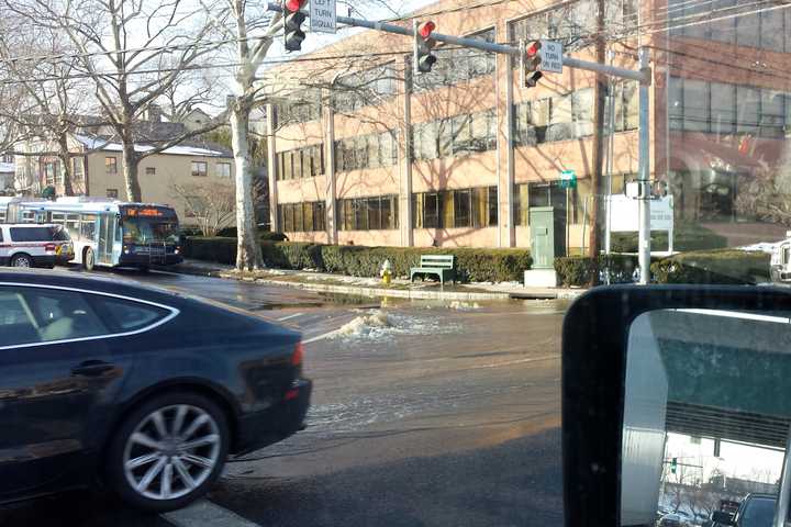 Water from a burst main floods the intersection of Arch Street and Railroad Avenue in Greenwich on Thursday.