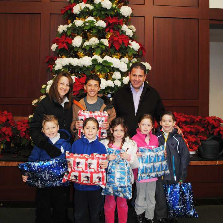 Marla and Keith Sernick and their six children, Jake (top center), Carson, Cooper, Katharine, Chloe and Reagan (l-r) visit Greenwich Hospital on Christmas Eve to deliver special presents for hospitalized children.