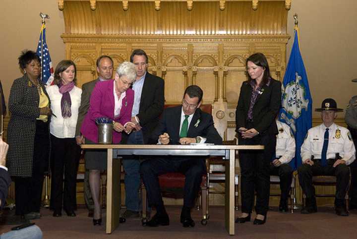 In April, Gov. Dannel Malloy signs into law a comprehensive legislative package on gun violence, mental health and school safety reforms. He was joined by family members of victims, anti-violence advocates and state officials. 