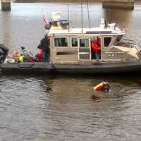 <p>Based on information that the woman found dead in the Saugatuck River last week was likely hit by a train, divers search the water below the Saugatuck River railroad bridge in Westport on Tuesday afternoon for evidence.</p>