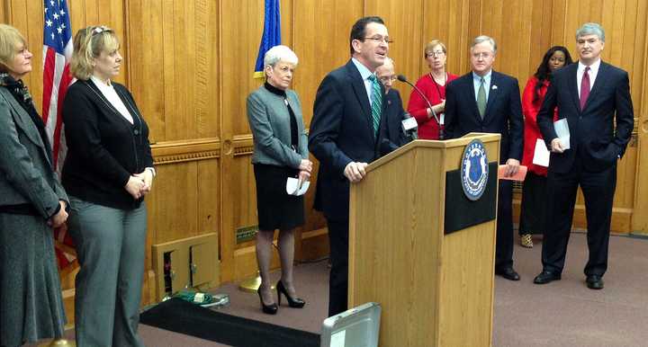 At a Monday news conference in Hartford, Gov. Dannel Malloy, joined by state legislators, advocates and small business owners, announces that a higher state minimum wage will go into effect on New Year&#x27;s Day.